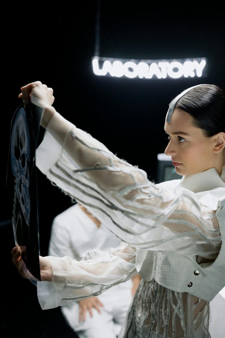 Focused female scientist in lab examining an x-ray for medical research