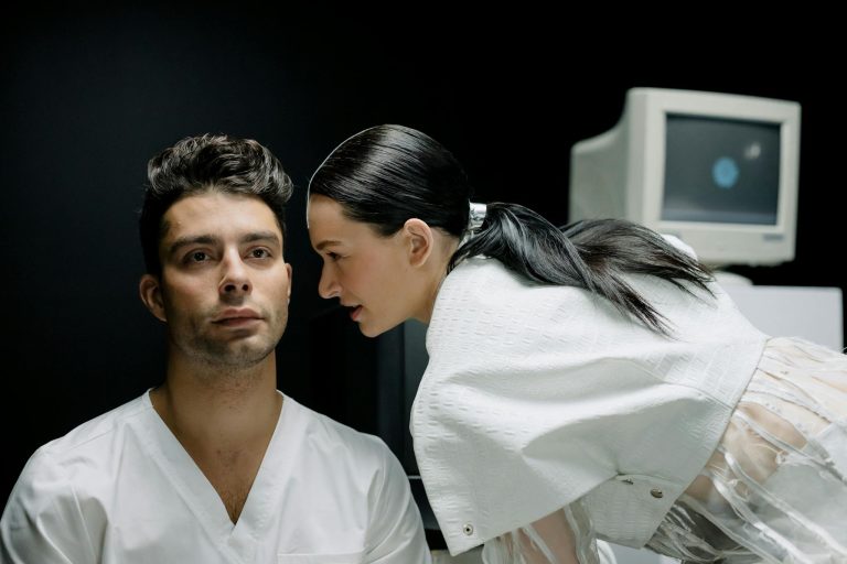 Man and woman in a laboratory setting, engaging in a focused conversation.